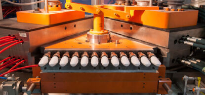 large orange plastic molding machine