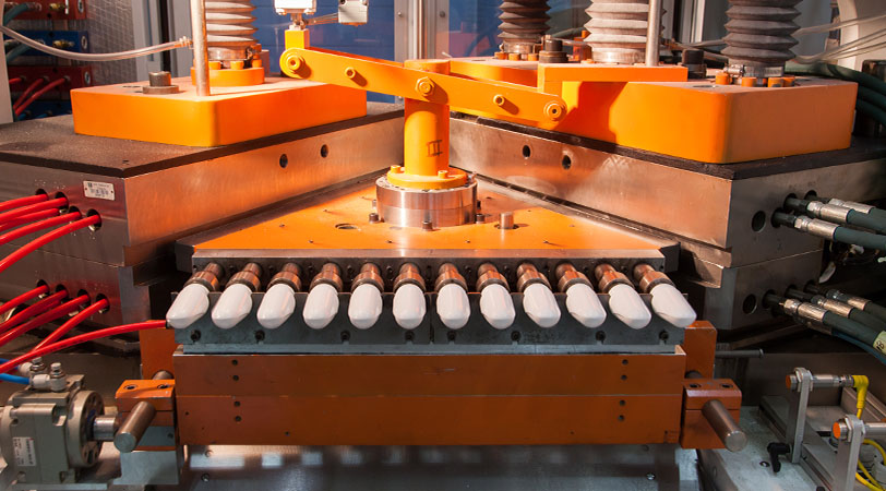large orange plastic molding machine